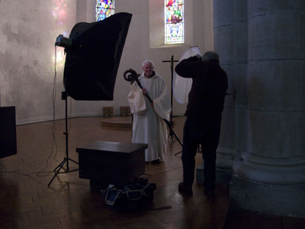 Dom Laurence posing for a portrait in the Abbey church