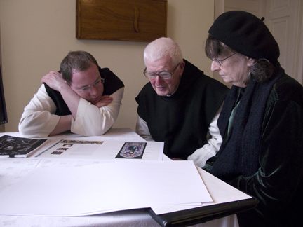 Dom Richard and Father Laurence look over initial page designs with Connie