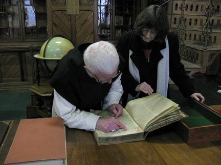 Father Laurence shows Connie the oldest book in the Abbey collection